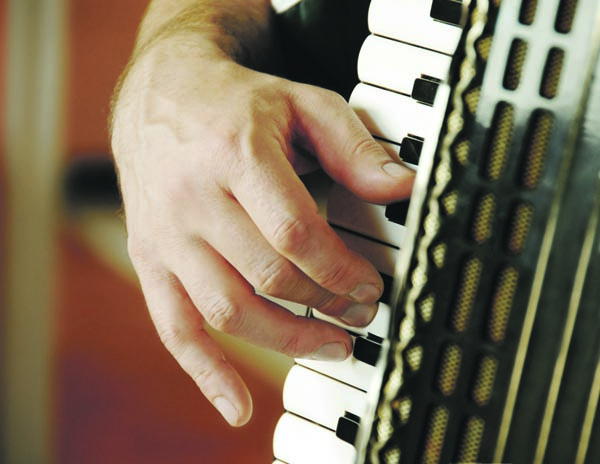 musician hand playing accordion